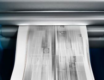 A newspaper being printed by a digital printing machine